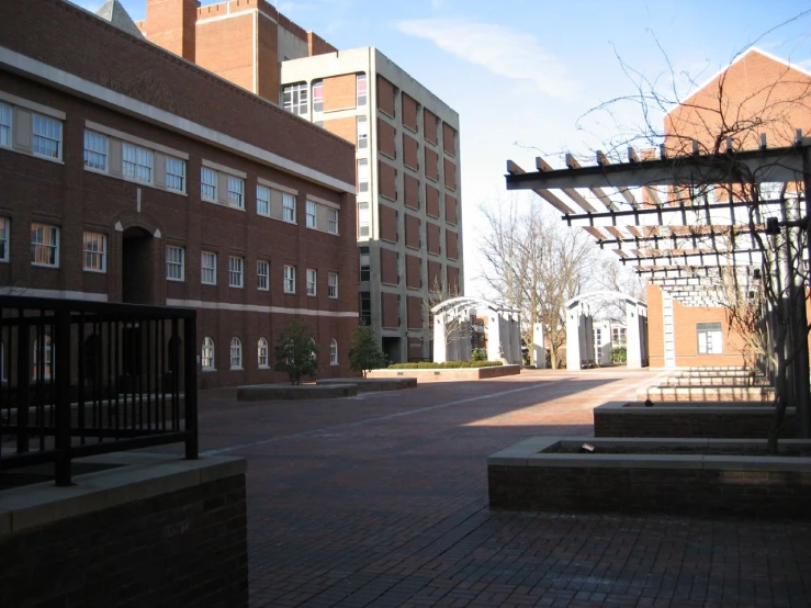 a large open courtyard with two buildings and courtyard entrance