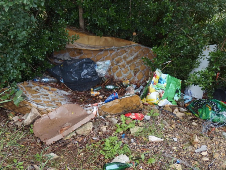 a pile of trash sitting on the side of a street