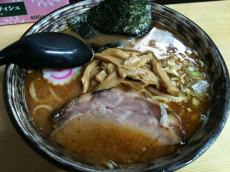 a plate with soup and broccoli with noodles