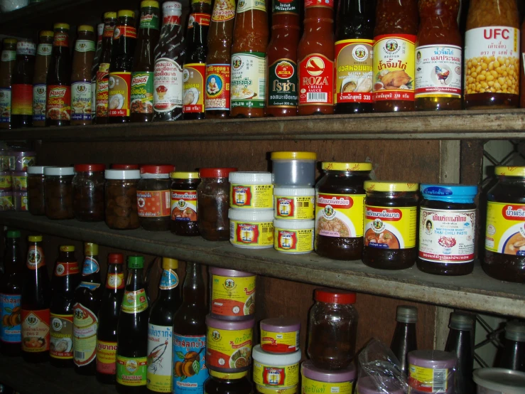 a shelf full of various kinds of food and condiments