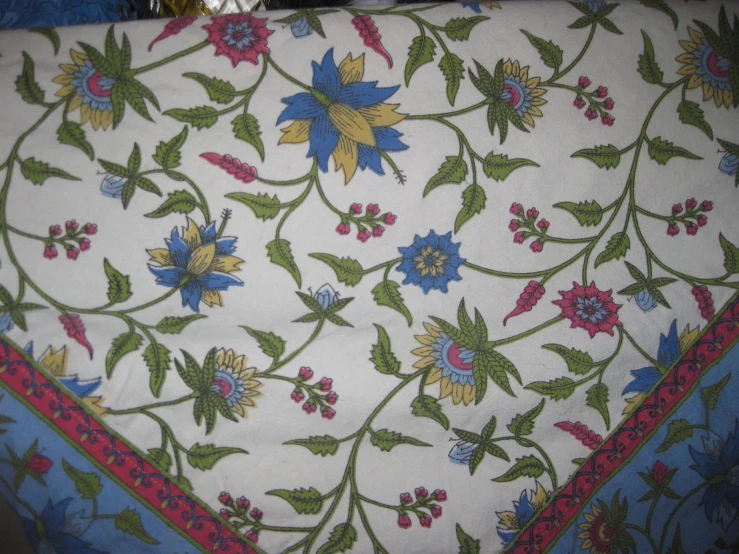 a red and blue table cloth with floral designs