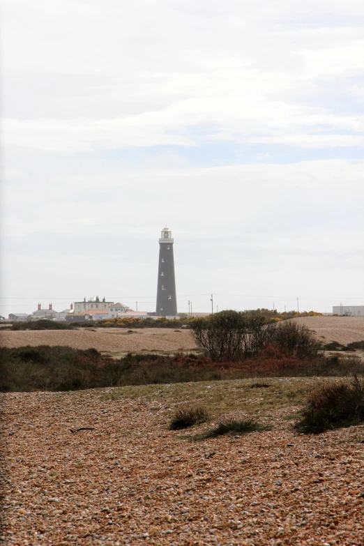 an image of a small lighthouse on a desert