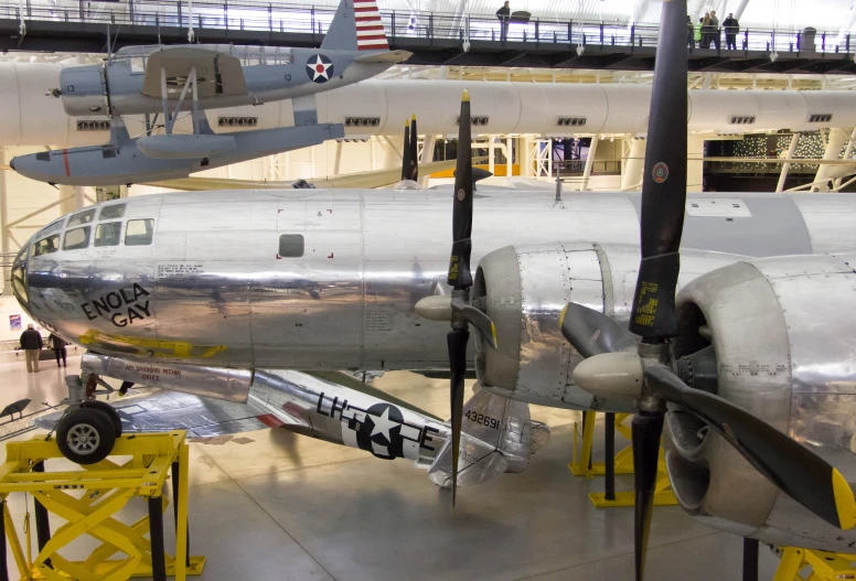 a bunch of airplanes in an airplane hanger