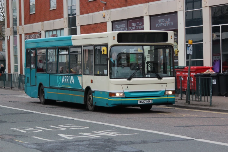 the transit bus is going down the city street