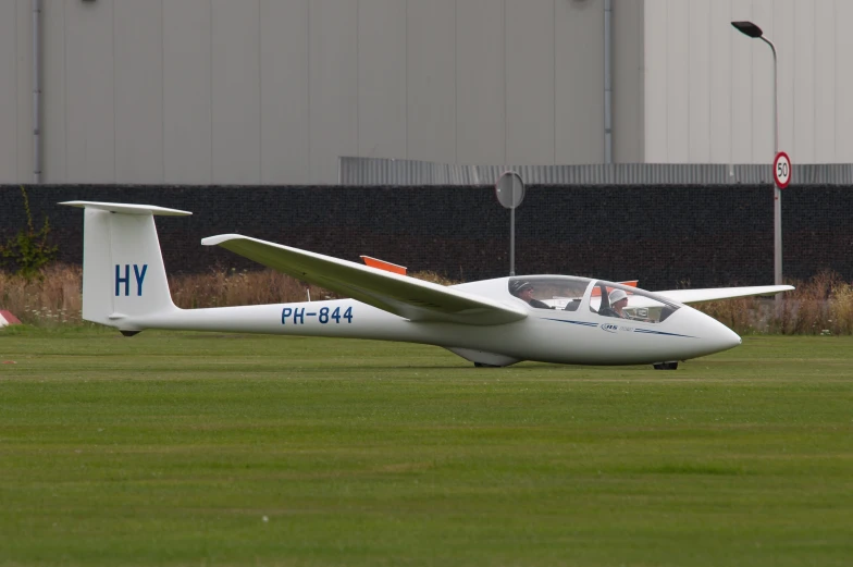 a small passenger airplane sitting in the middle of a field