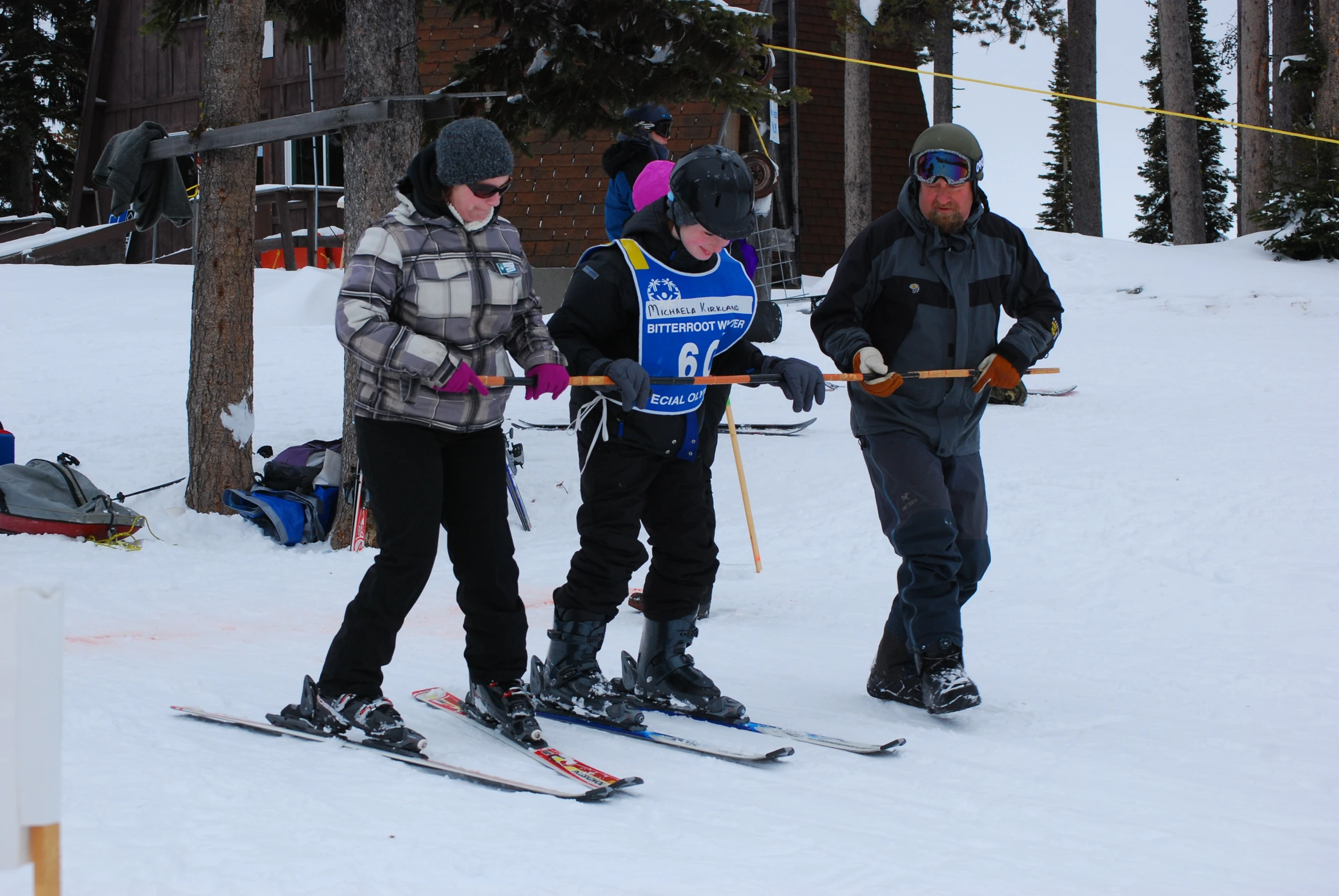 the three skiers stand by themselves waiting for their turn