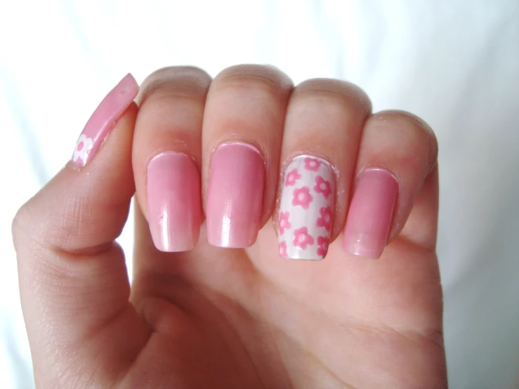 an attractive manicure with pink and white flowers