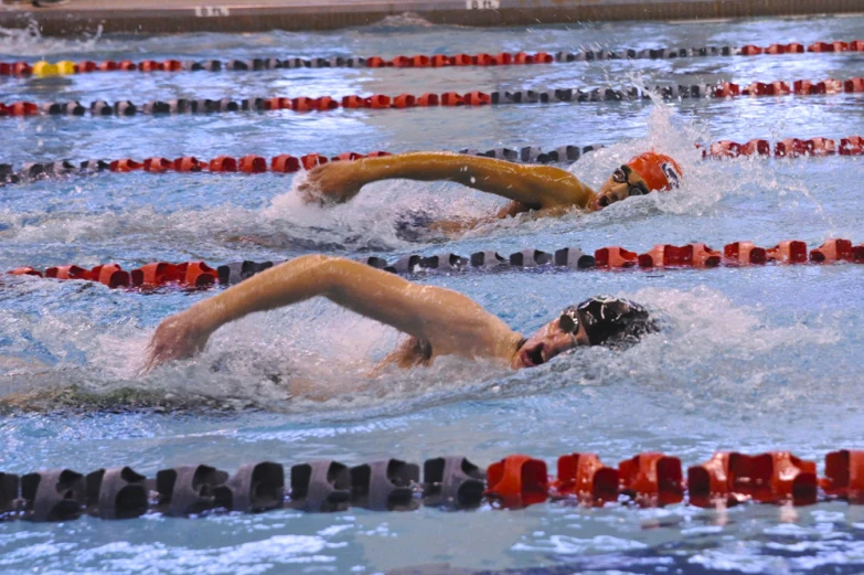 a group of swimmers racing in a pool