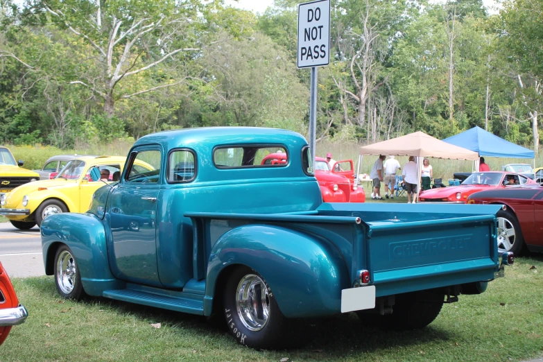 a blue pickup truck at an auto show