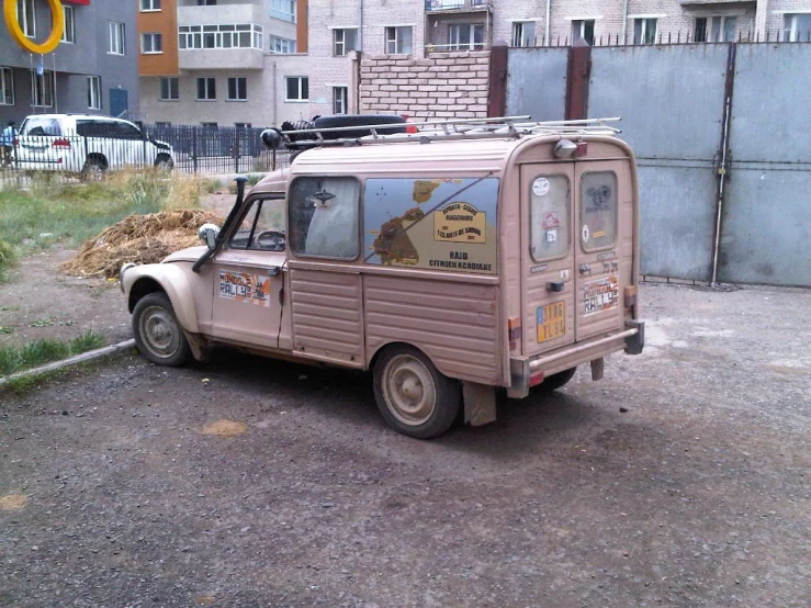 an old beige truck is parked in a lot