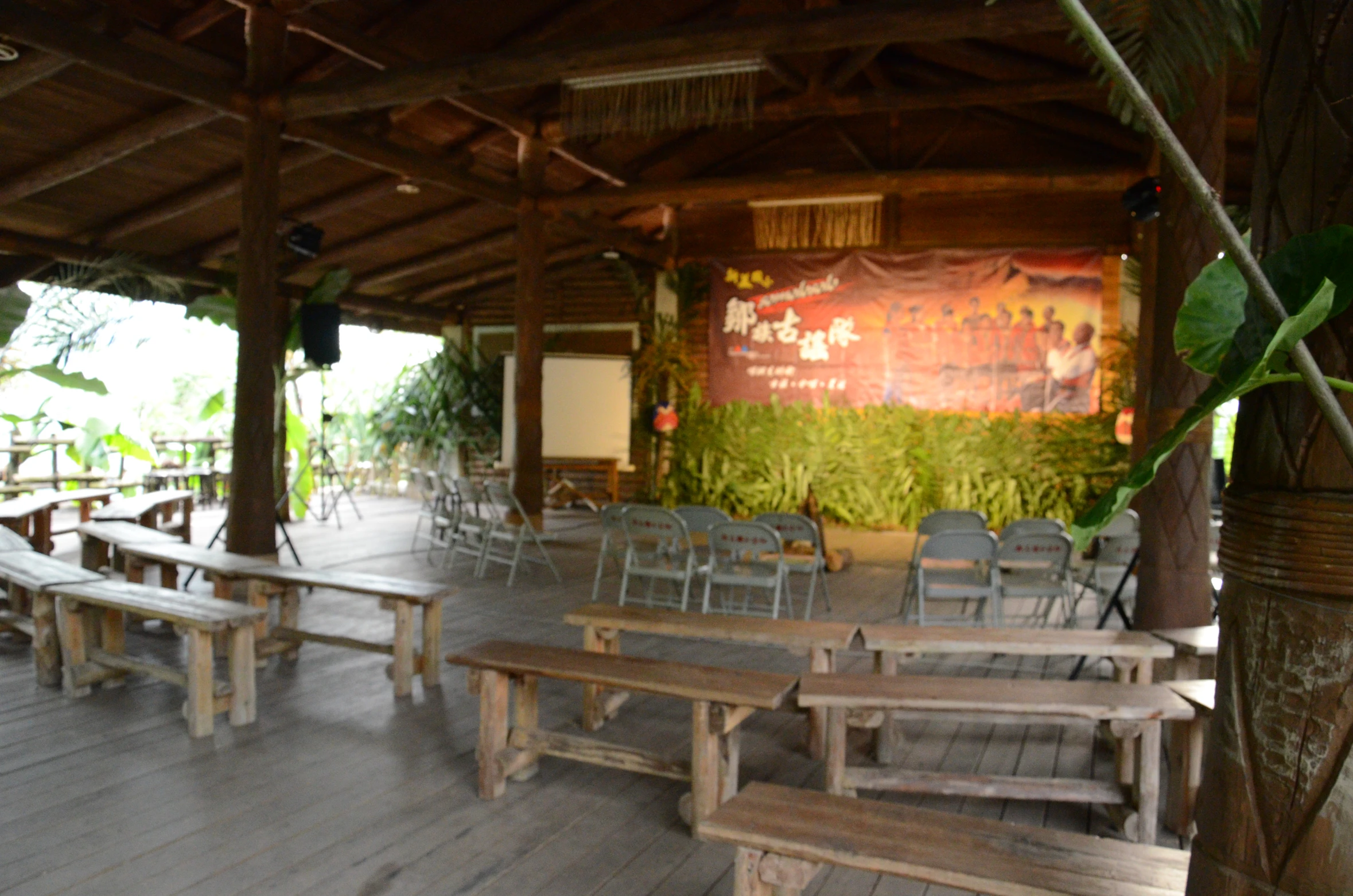 empty tables and chairs sit at an outside table area