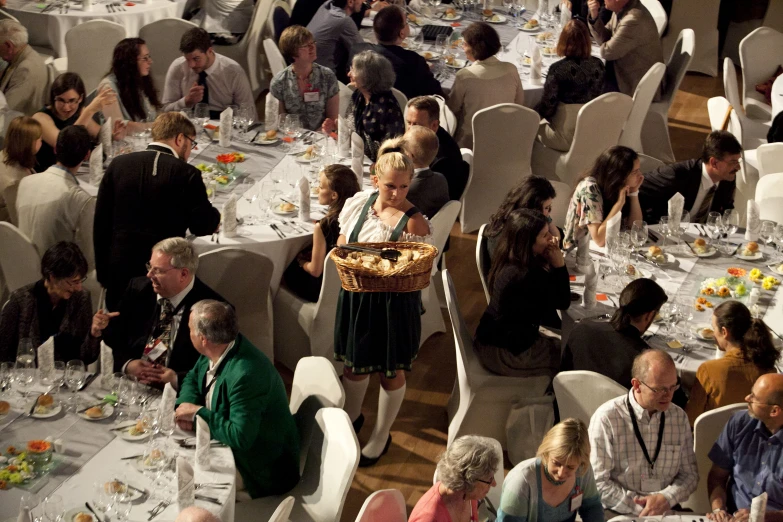 a woman with an ornate basket is standing over the table