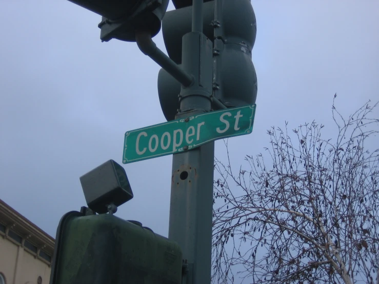 a green street sign sitting on the side of a metal pole