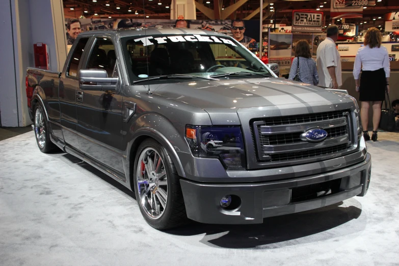 a gray truck on display at an automobile show