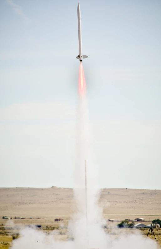 a large jet flying in the air with smoke coming out of it