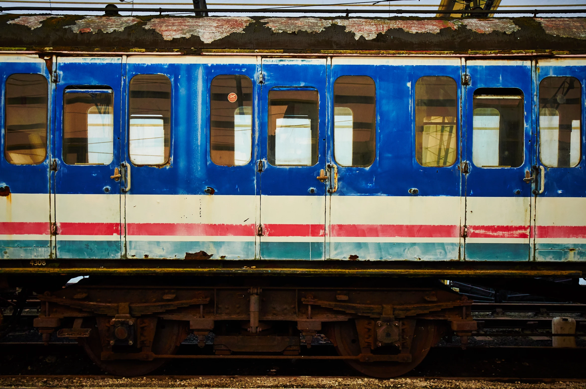 this is the side of an old rusty passenger train