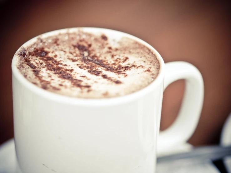 there is a cup of  chocolate on the saucer