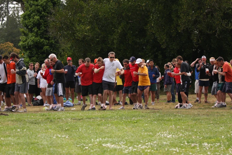 a group of people standing in a field