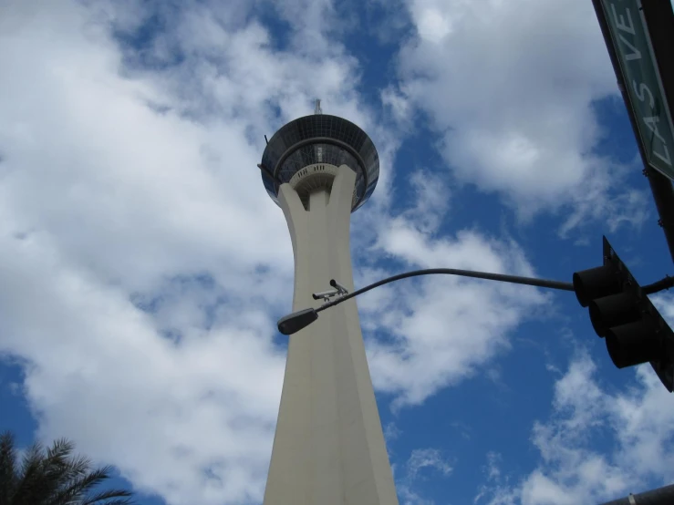 a tall building with a spire that has a sky background