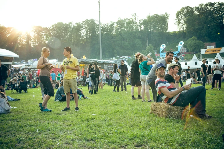 a group of people standing around in a field