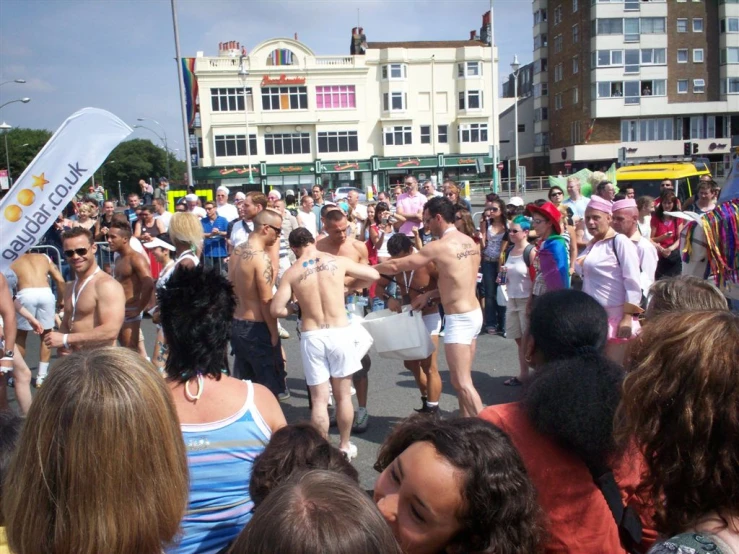 a large group of people in bathing suits on a city street