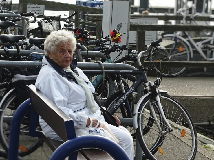 a woman sitting on a bench next to bikes