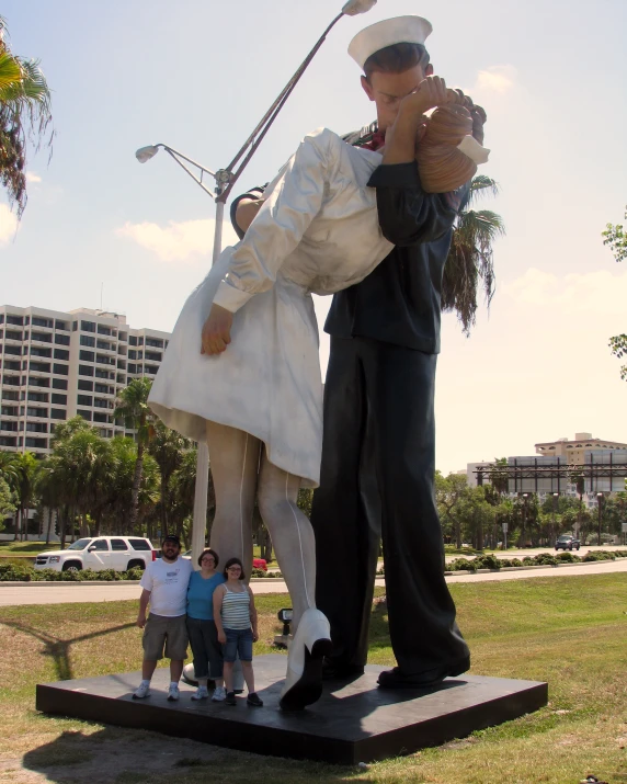 a man taking pictures in front of a statue