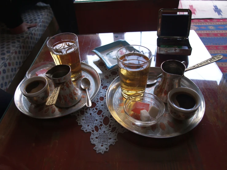 a couple of tea pots sitting on top of two plates