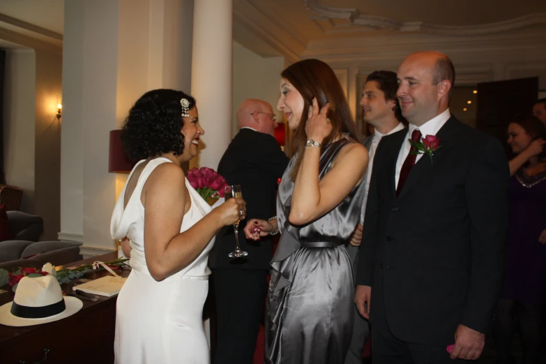 a woman talking to two men in suits