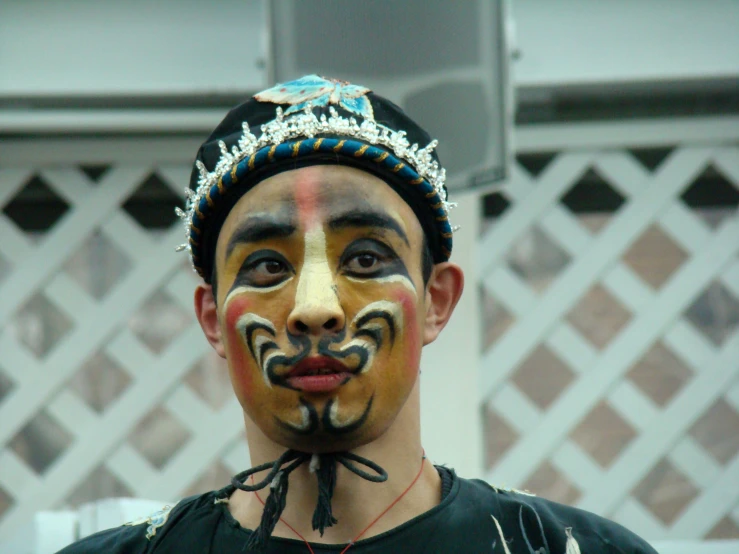 a man with a very strange looking face is wearing makeup