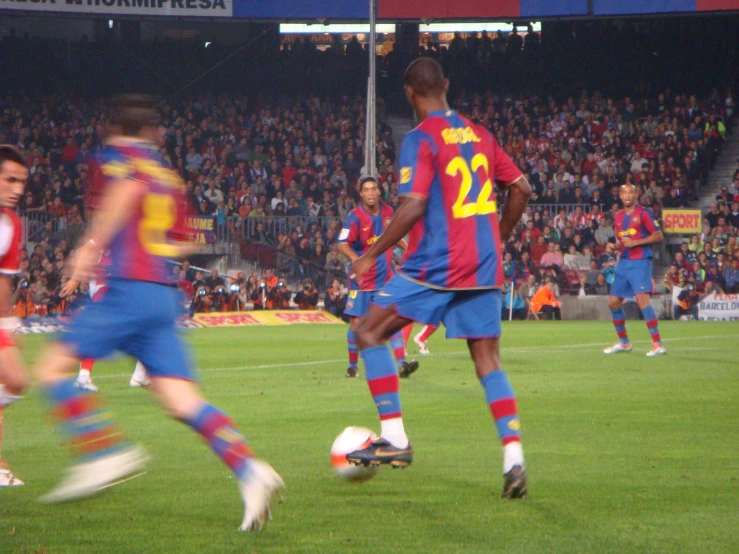 a soccer player on the field running for the ball