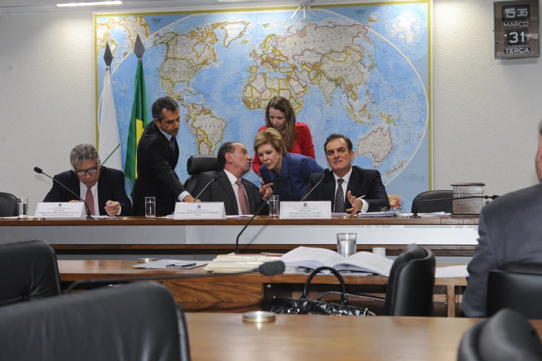 group of business people sitting in front of the world map