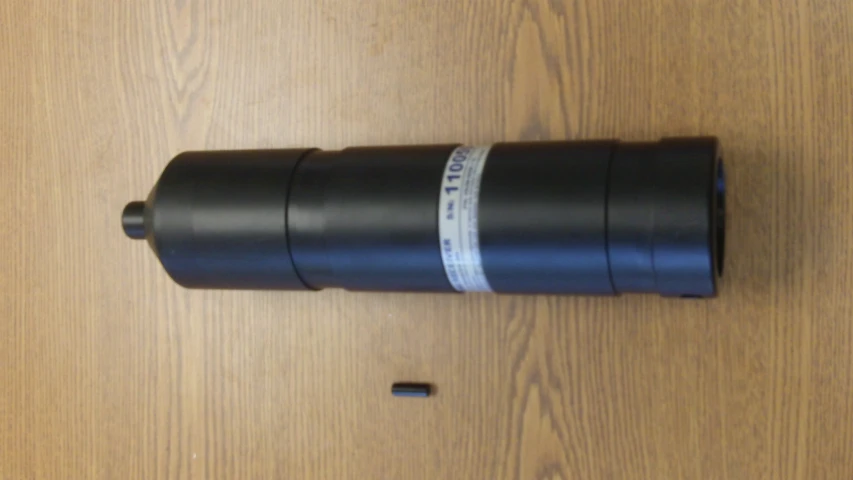 a telescope lens on the ground with its cap off