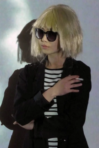 a woman with sunglasses, a jacket and arm around her shoulders