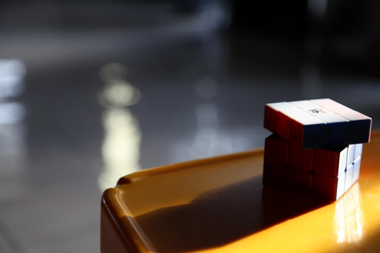 a little toy cube sitting on top of a yellow tray