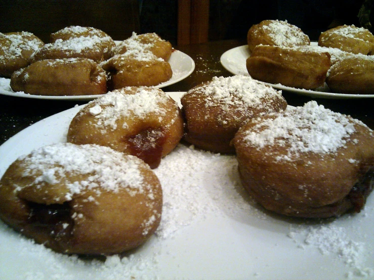 powdered sugar covered pastries on display at a restaurant