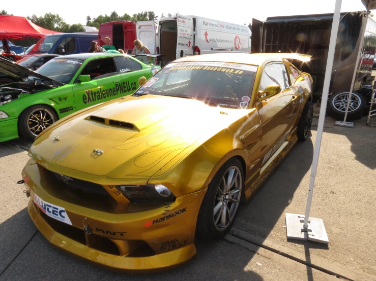 the gold car was parked under a blue flag