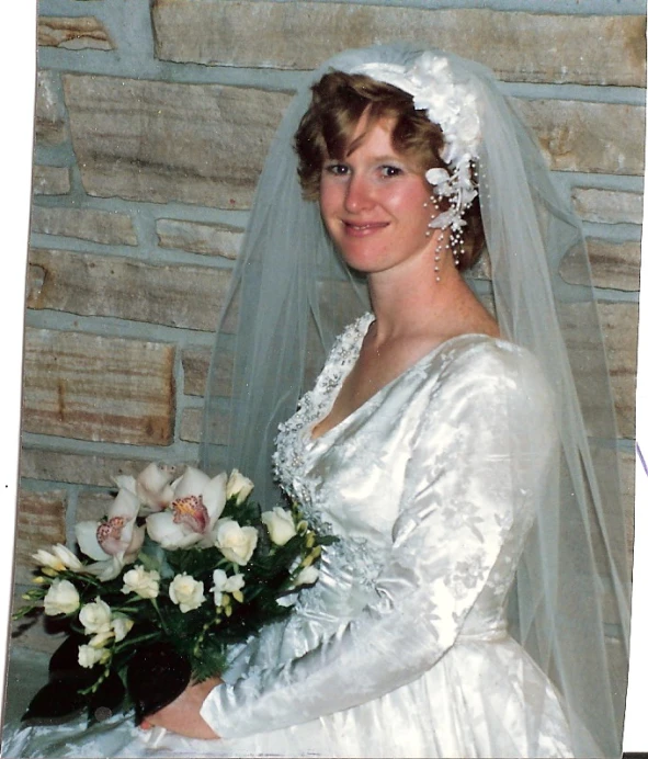 an old fashioned picture of a beautiful bride wearing a veil