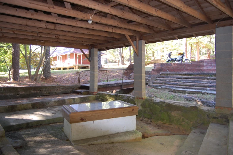 a concrete bench on the ground next to stairs