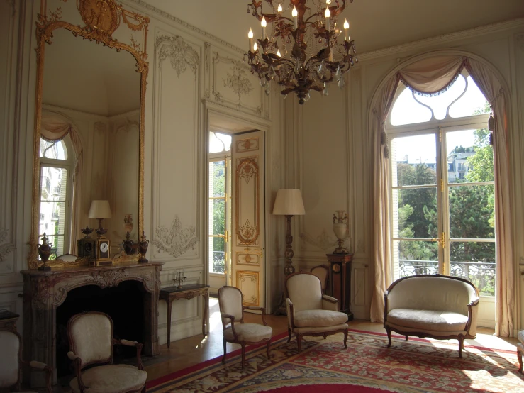 a beautiful white sitting room has several chairs