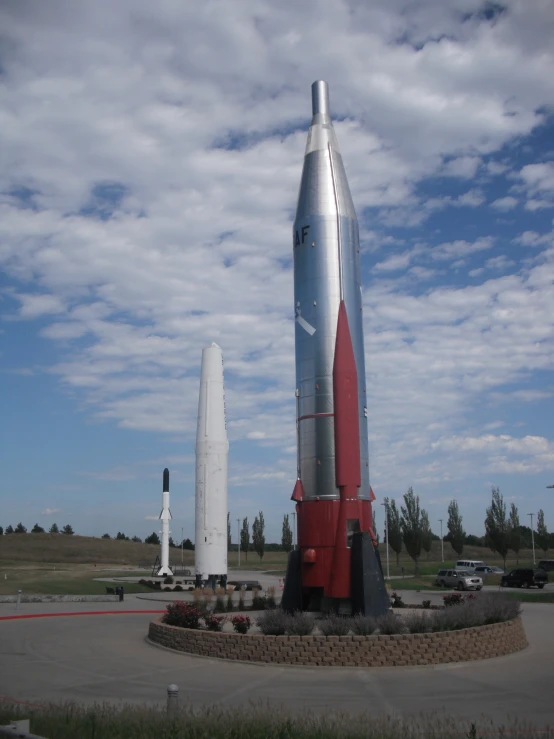 two different sized rockets are in a large lot