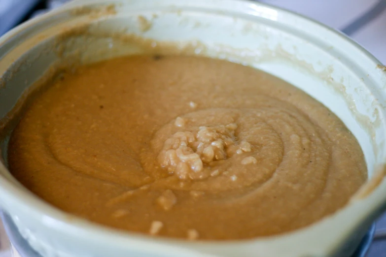 the sauce is a brown color and is filled with nutmeal