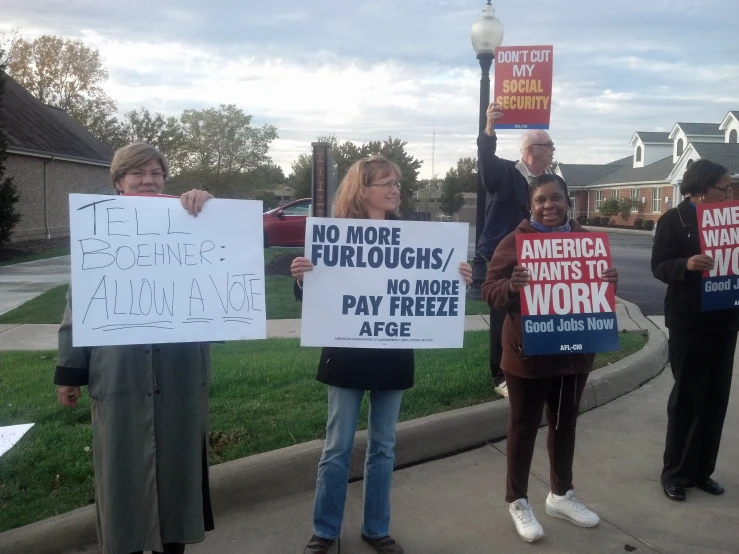 protestors with signs protesting obama's work