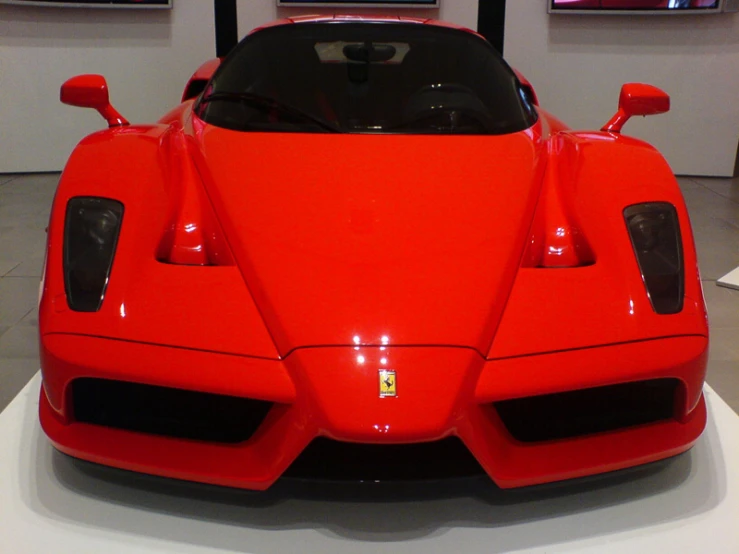 red sports car on display at a car museum