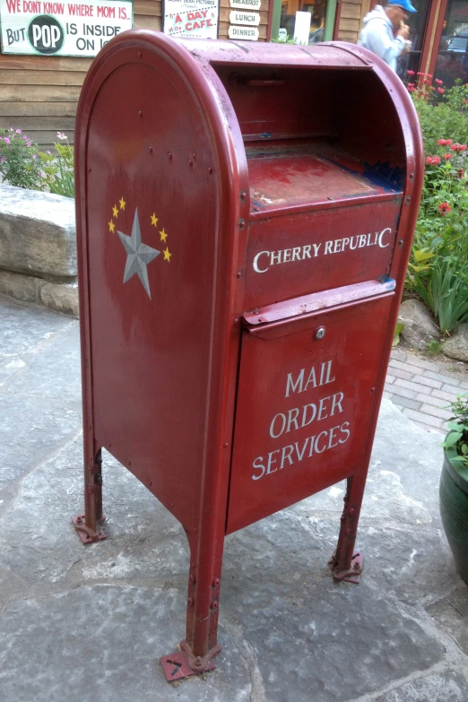 an old red mailbox with a star logo and lettering