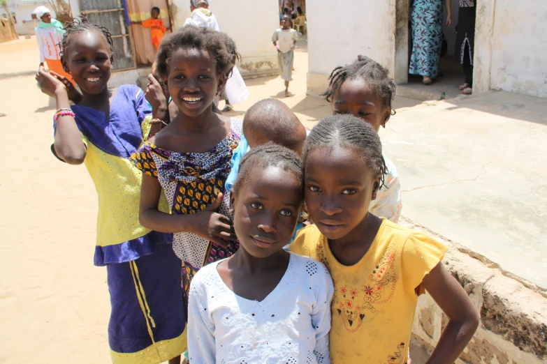 there are children standing together outside the building