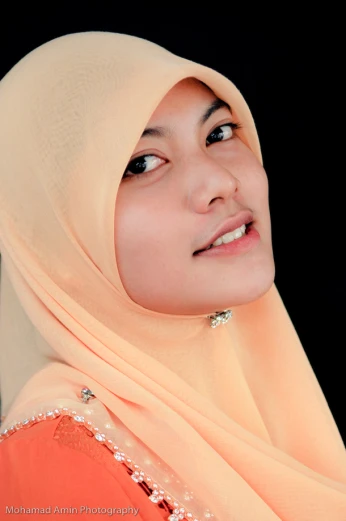 a woman wearing an orange hijab