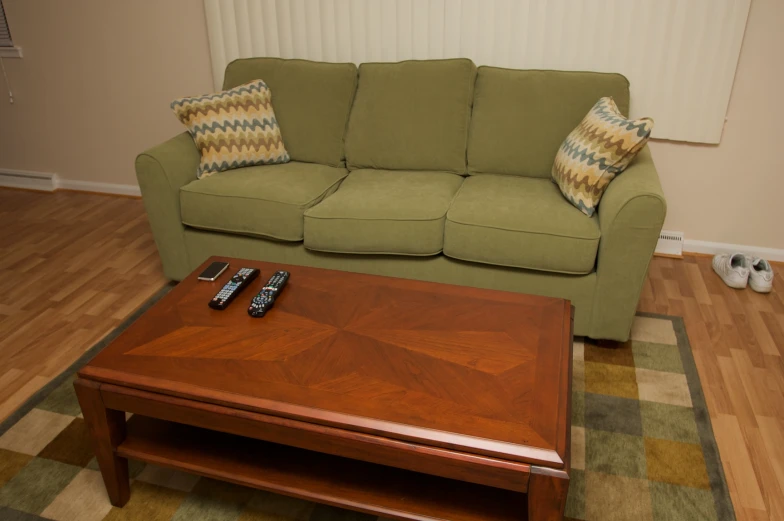 a coffee table is between two sofas in a living room