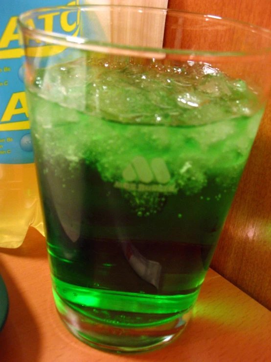 a very pretty green beverage in a glass on a table