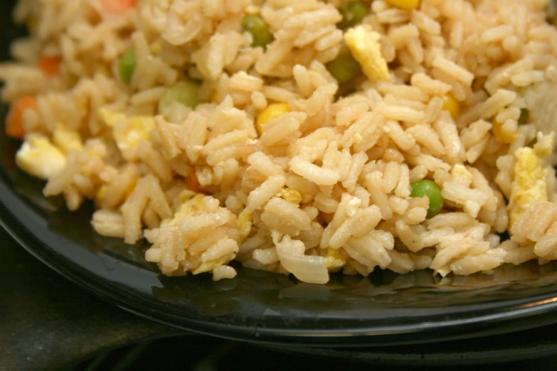 a close up of rice and vegetables in a bowl